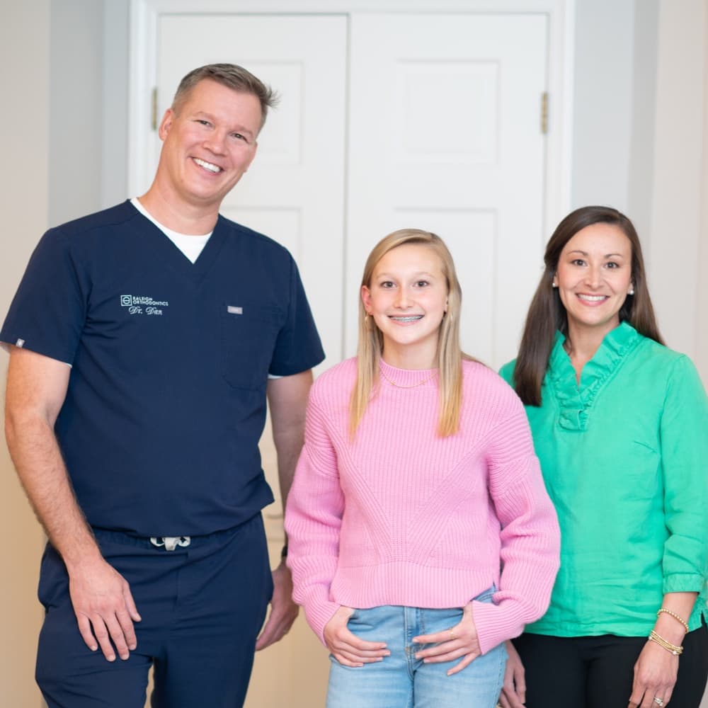 family smiling during orthodontic appointment